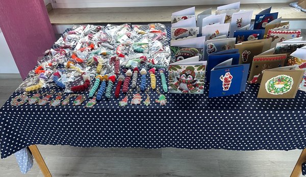 Basartisch mit gehäkelten Sorgenwürmchen und Weihnachtskarten 